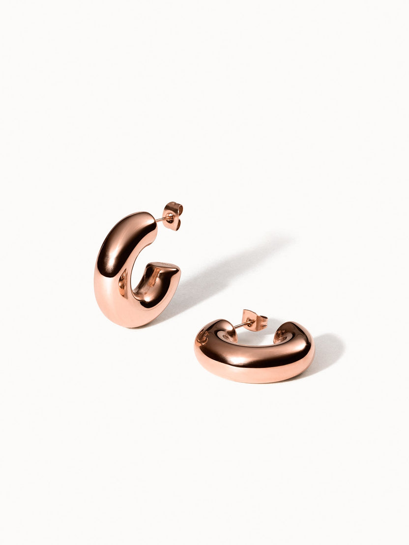 Roségoldene PURELEI Small Stellar Glow Ohrringe mit sanftem Glanz auf minimalistischem weißem Hintergrund.