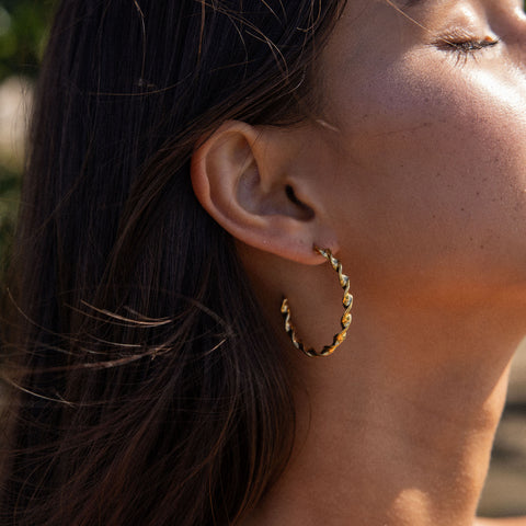 PURELEI Kaula Creole Ohrringe aus 18K vergoldetem Edelstahl mit gedrehtem Design, elegant und zeitlos getragen.