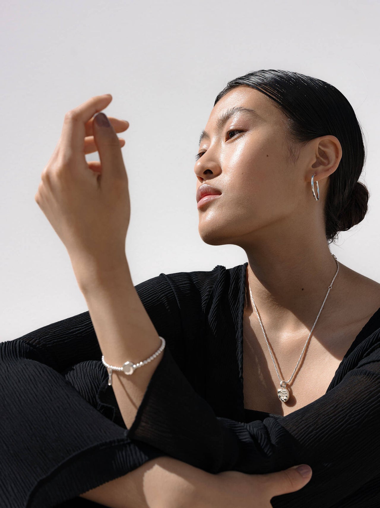 Essentisches PURELEI Essence Armband aus recyceltem Silber mit glänzenden Kugeln und elegantem Coin am Handgelenk.
