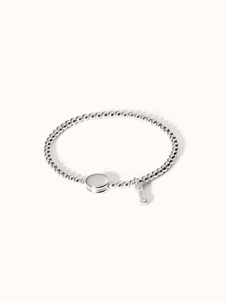 Silbernes Armband mit glänzenden Perlen und rundem Anhänger von PURELEI.