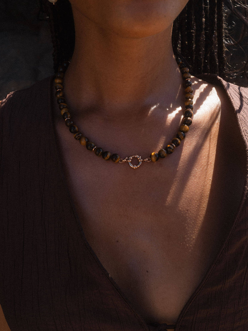 Braune Perlenkette mit goldener Verschlussdetails von PURELEI, elegant und natürlich.